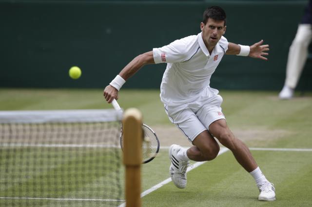 Novak Djokovic of Serbia plays a return to Roger Federer of Switzerland during the men's singles final at the All England Lawn Tennis Championships in Wimbledon, London, Sunday July 12, 2015. (AP Photo/Pavel Golovkin)