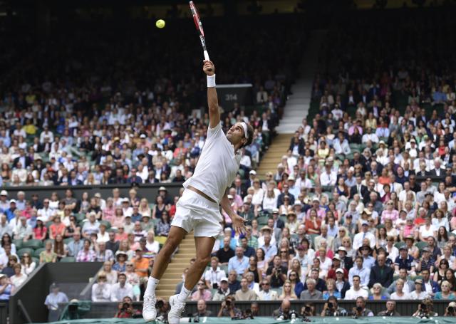 Roger Federer of Switzerland reaches for a ball during the men's singles final against Novak Djokovic of Serbia at the All  England Lawn Tennis Championships in Wimbledon, London, Sunday July 12, 2015. (Toby Melville/Pool Photo via AP)