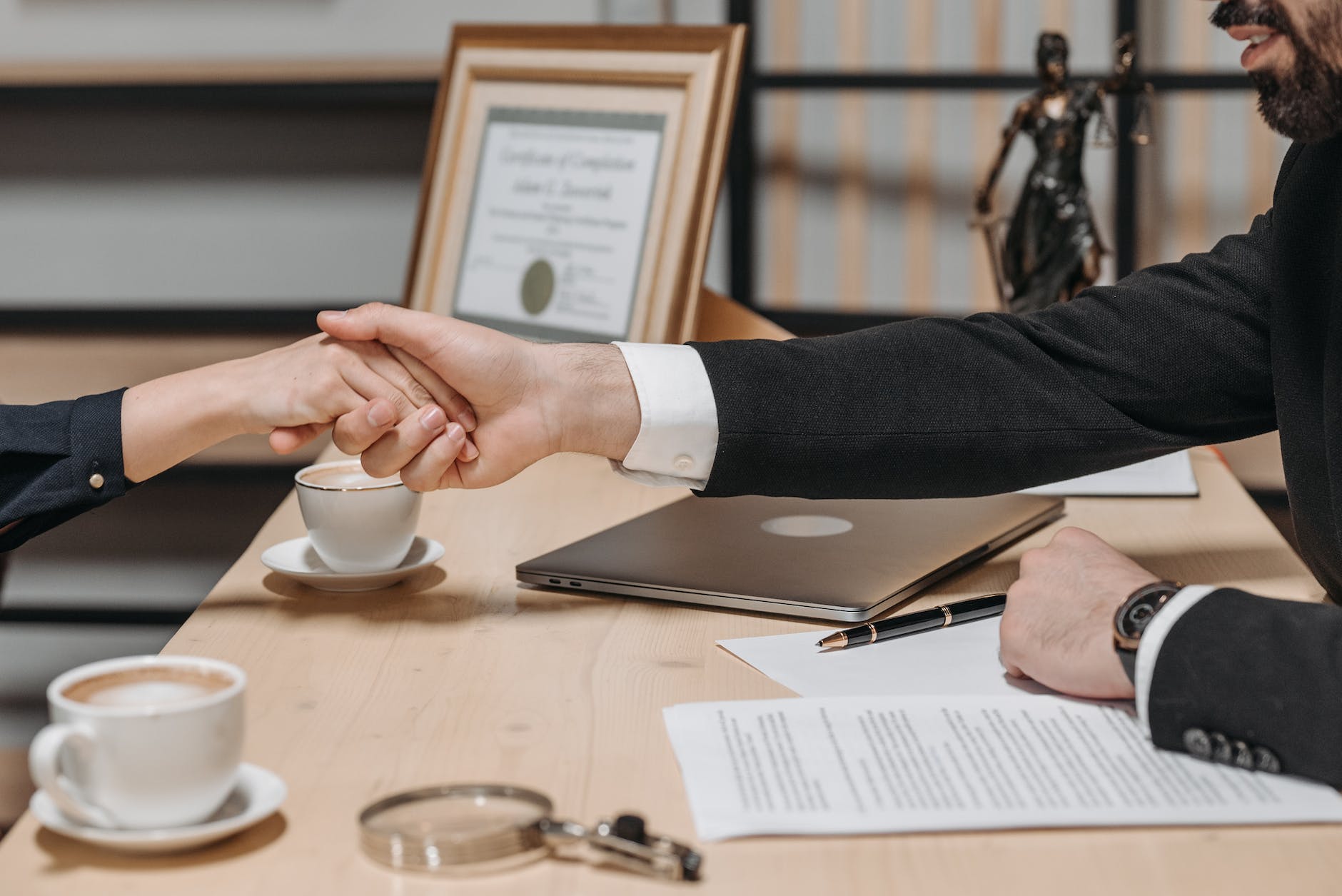 people shaking their hands in close deal business contract