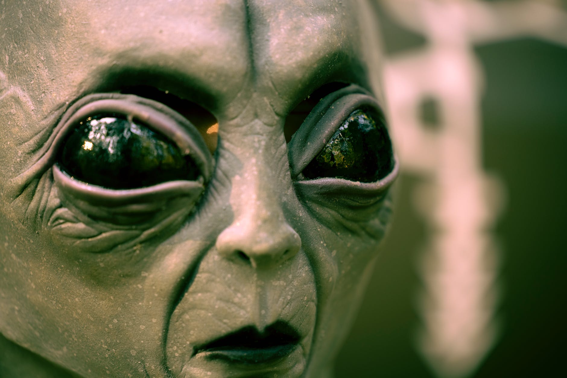 gray alien mask with big black eyes